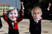 Антиглобалисты в масках Ангелы Меркель и Владимира Путина перед началом форума