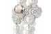 Часы Les Eternelles de Chanel Camélia Secret Watch из коллекции Les eternelles de Chanel украшены жемчугом и бриллиантами, самый главный из которых - коньячный весом 10 карат. Часы созданы в единственном экземпляре, стоимость - 723 796 франков