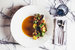 В 15 Kitchen + Bar новый гостевой шеф — американец Кристофер Арианес, в резюме которого работа под руководством знаменитого шефа Дэниеля Хумма в Eleven Madison Park, отмеченном треми звездами «Мишлен». В Москве Арианес будет готовить, как в Нью-Йорке: в меню кальмар со сладким перцем и водорослями, скумбрия и капуста с горчицей и тмином, морепродукты с томатным минестроне и вяленой кониной, а также медовая утка, считающаяся одним из бестселлеров Eleven Madison Park