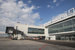 Проект разрабатывали архитектурное подразделение Hintan Associates и Signy group. В архитектуре здания использован прием четкой геометрии, но под козырьком снова просматривается волна на фасаде