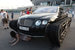 13 июня 2019 г. Девушка позирует рядом с гусеничной машиной Bentley Continental GT, которая была модифицирована российскими автолюбителями