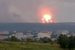 Взрывы на военном складе с боеприпасами начались приблизительно в 13.00 мск. Источник ТАСС в экстренных службах рассказал, что разлет осколков от взрывающихся снарядов достигал 15 км. По его словам, горели две площадки по утилизации, на них находилось 40 000 артиллерийских снарядов